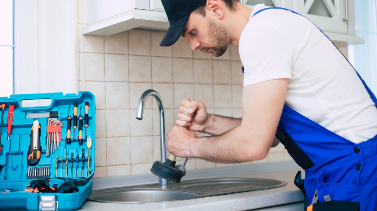 plumber doing drain cleaning